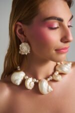Model wearing Lost Atlantis Murex Shell Earrings with natural shell jewelry set