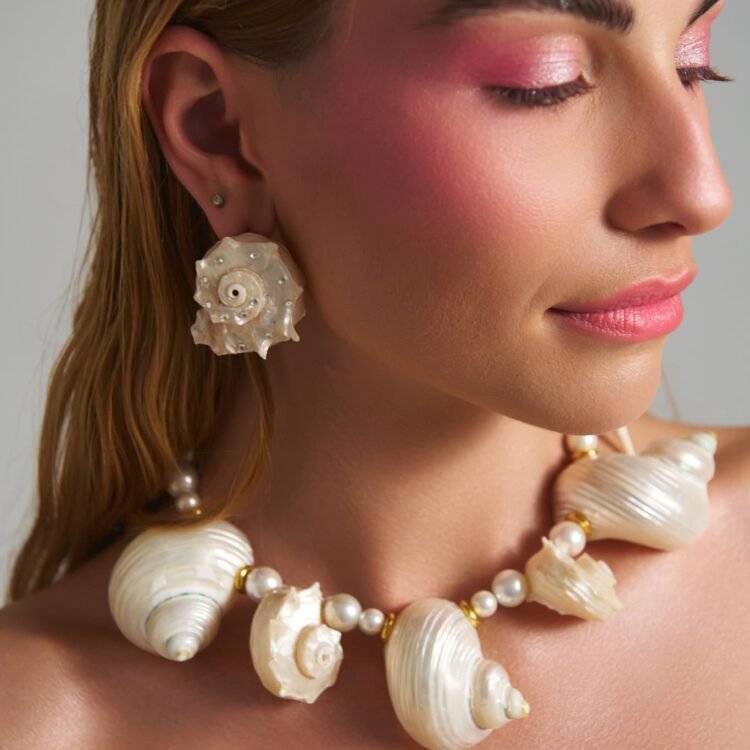 Model wearing Lost Atlantis Murex Shell Earrings with natural shell jewelry set