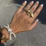Stainless steel bird ring with flying swallow design.