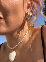 Stainless steel celestial earrings with gold and silver elements.