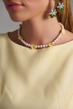 Handmade freshwater pearl necklace with yellow ceramic flowers.