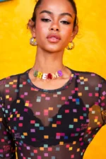 Statement letter necklace spelling DREAMS in green, yellow, pink, red, orange and purple plexiglass